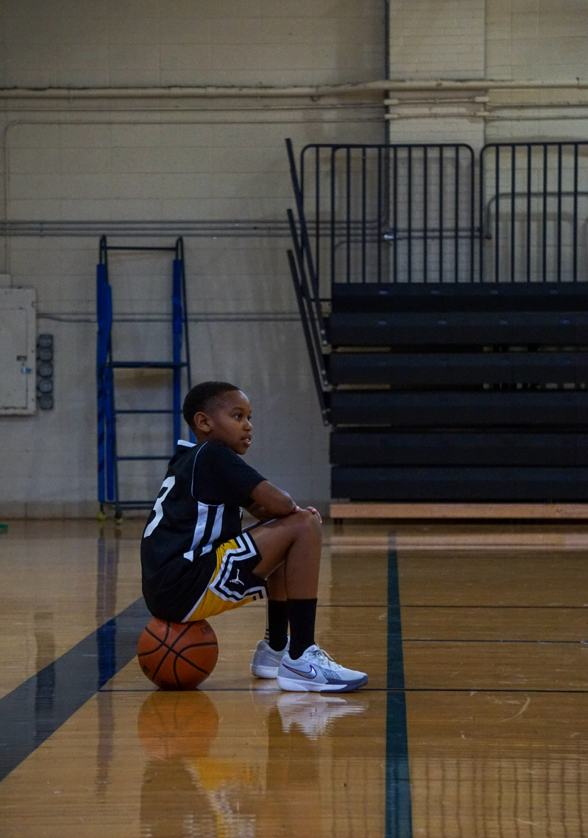 HBA player in thoughtful moment on basketball court